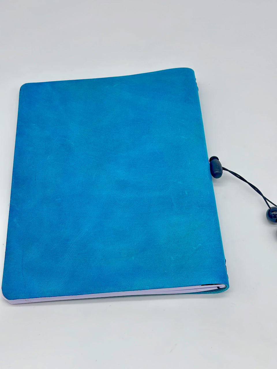 back cover of a blue leather covered journal