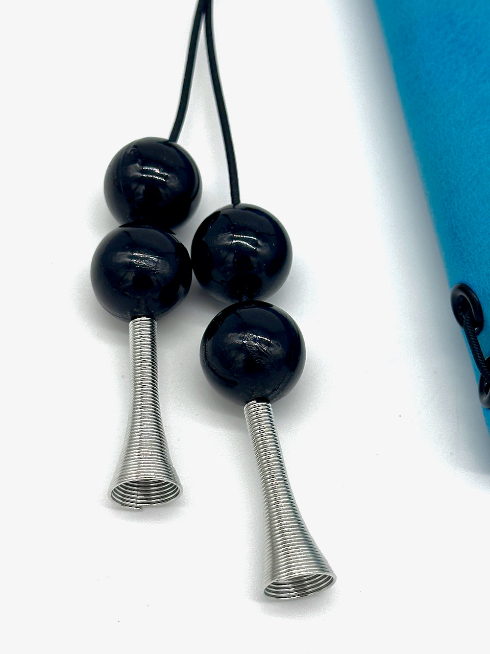 close up of black glass beaded tassel on a blue flowered leather journal cover