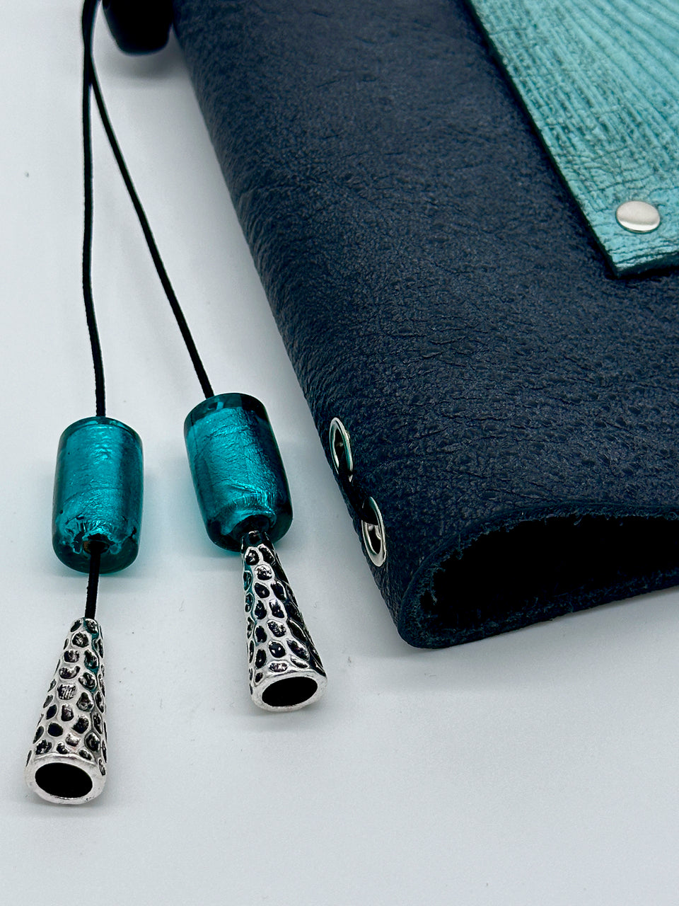 detail of glass and silver beads on tassel of leather journal by undercover popular leather goods