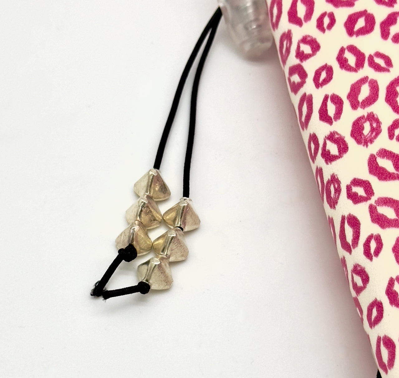 detail of silver beads on tassel toggle on refillable leather journal
