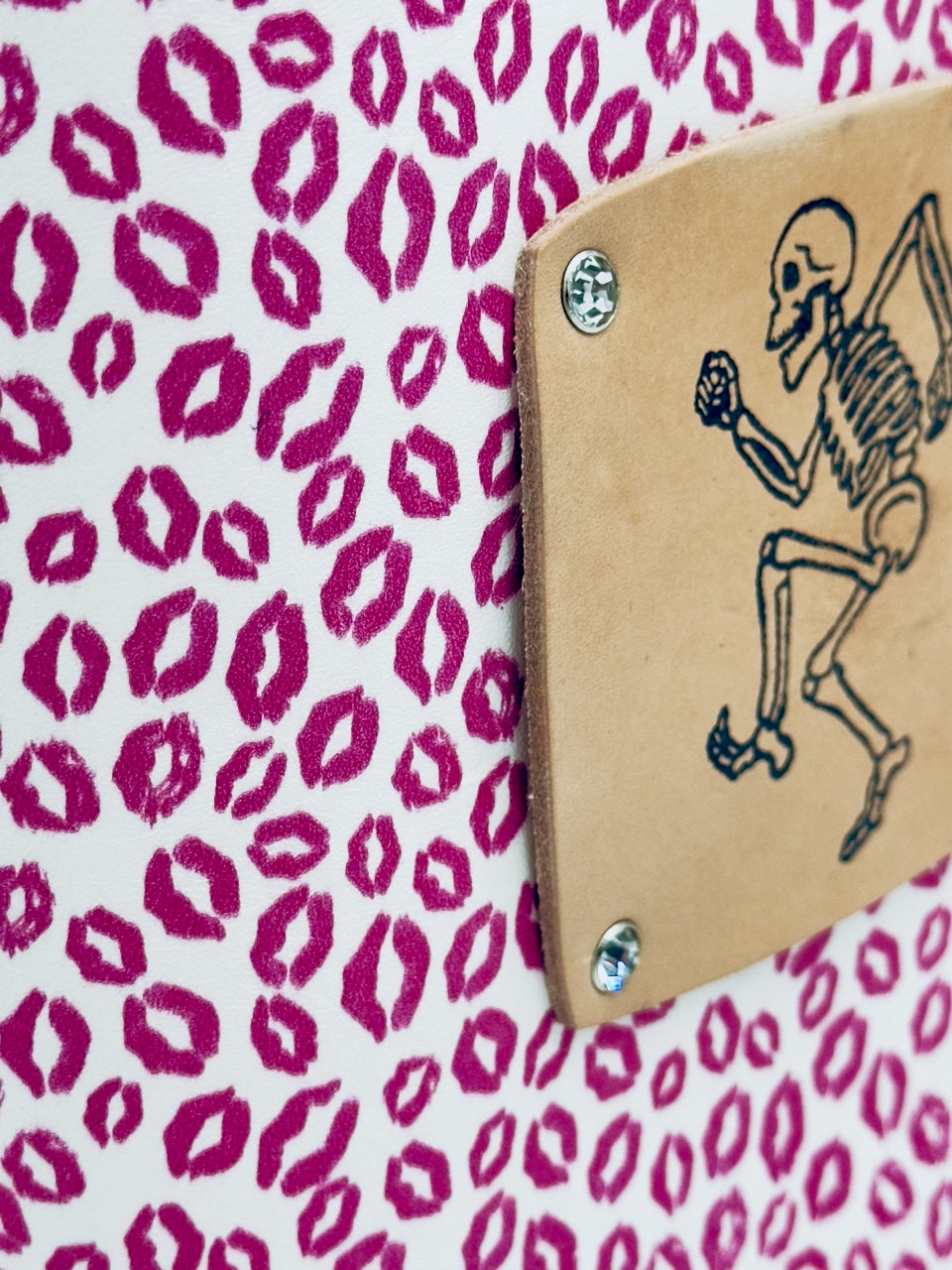 side angle of stamped dancing skeleton on leather journal cover