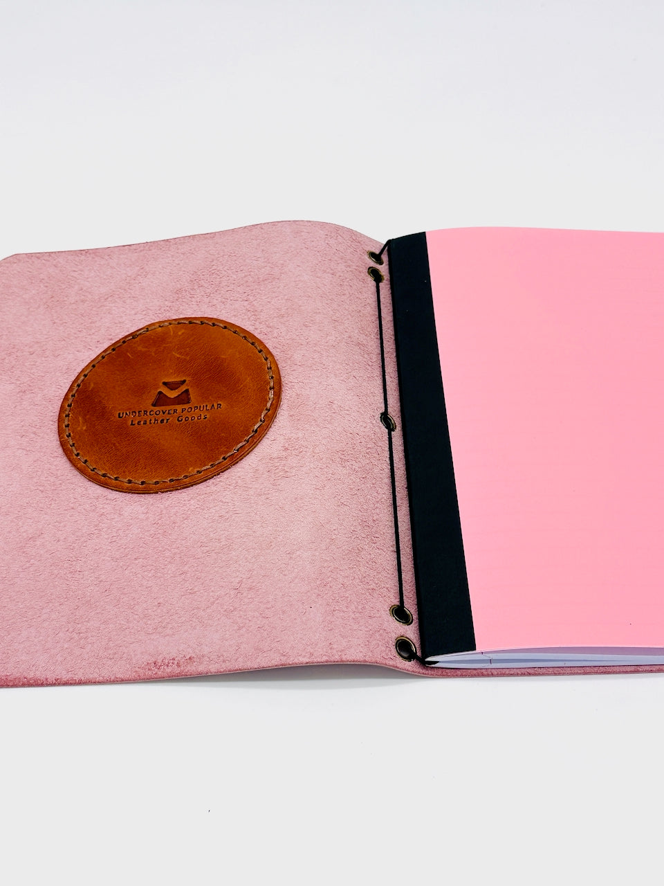 Interior of Leather Journal shows elastic cord for easy paper replacement