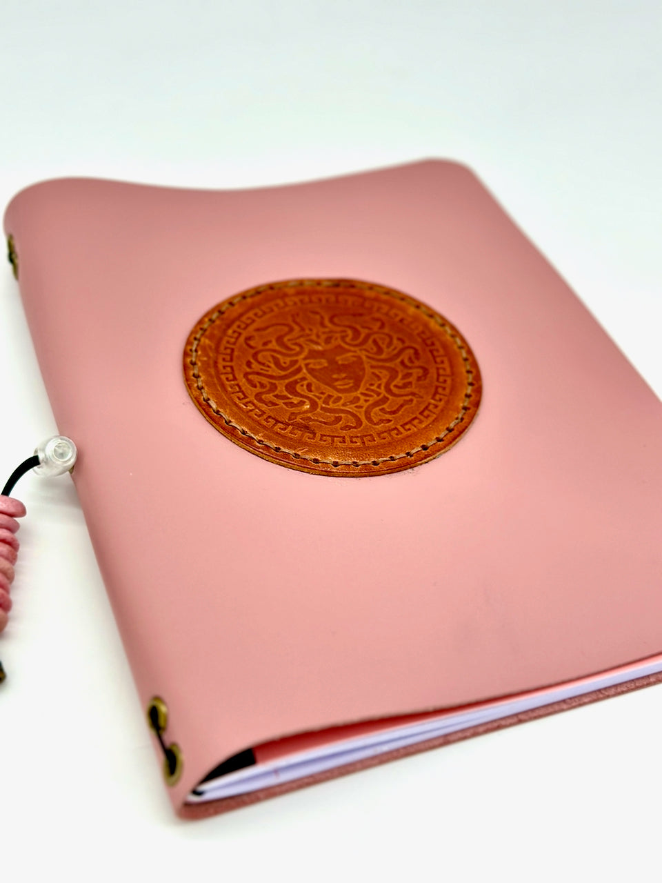 Low angle Leather Journal cover in pink with Medusa image from undercover popular