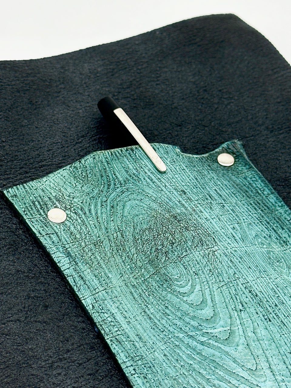 detail of pen holder flap on leather journal cover