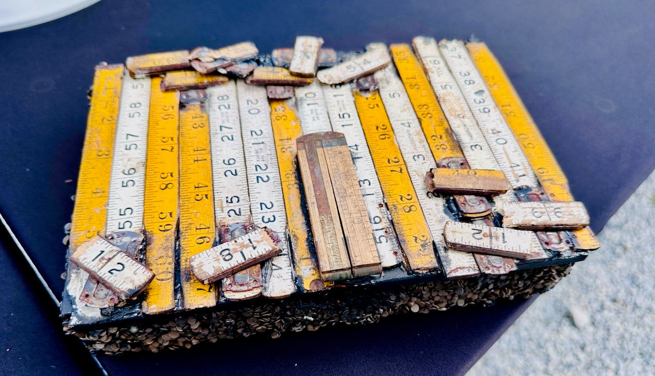 Collection of used measuring tapes with visible measurements on a dark surface