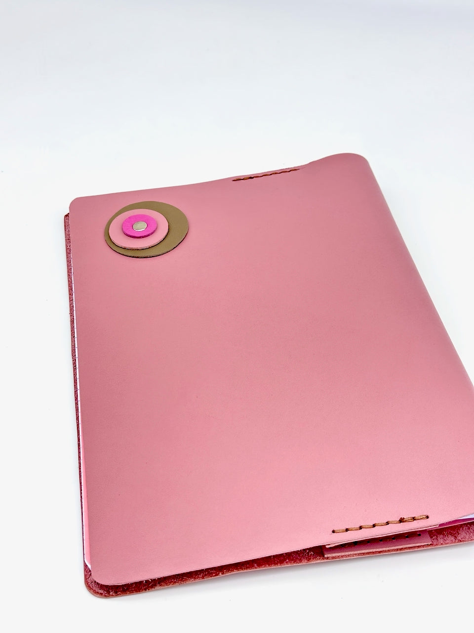 back cover of pink leather journal with circles and rivet
