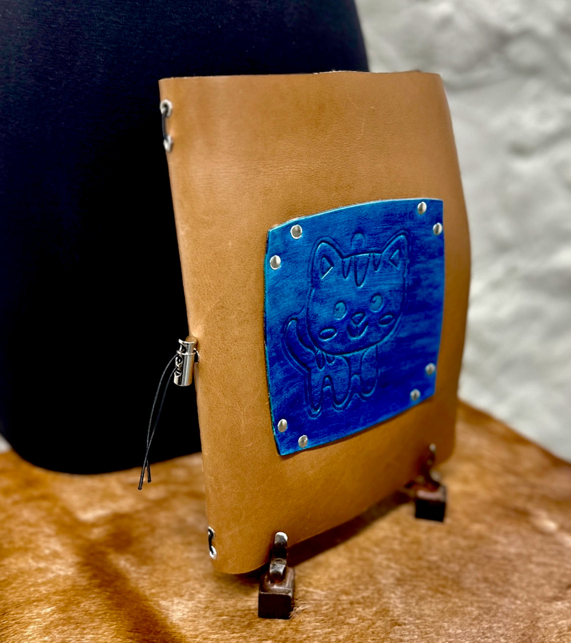 Brown leather journal with a blue embossed leather cat on front cover