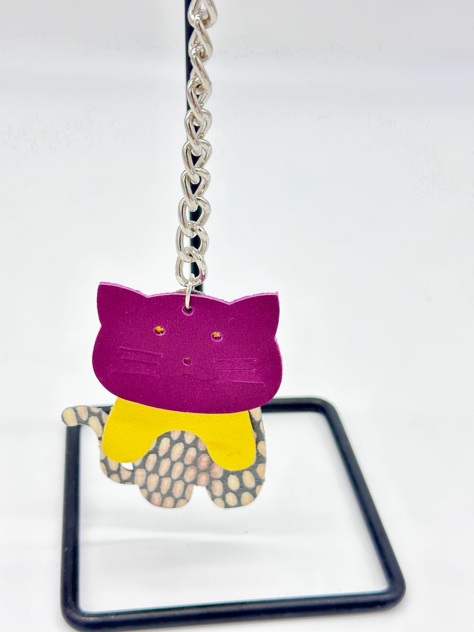 hanging cat key chain made in vioet, yellow and patterned patent leather