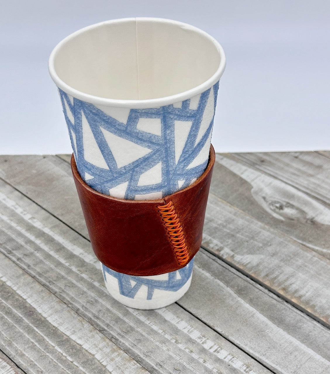 cognac brown leather coffee sleeve with orange stitching