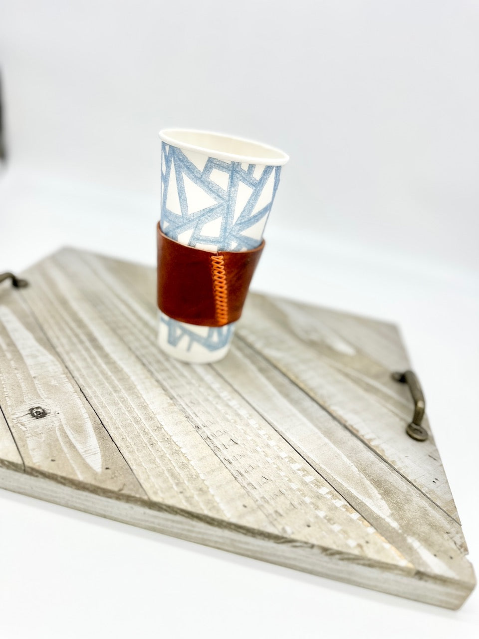 cognac brown coffee sleeve on wood board