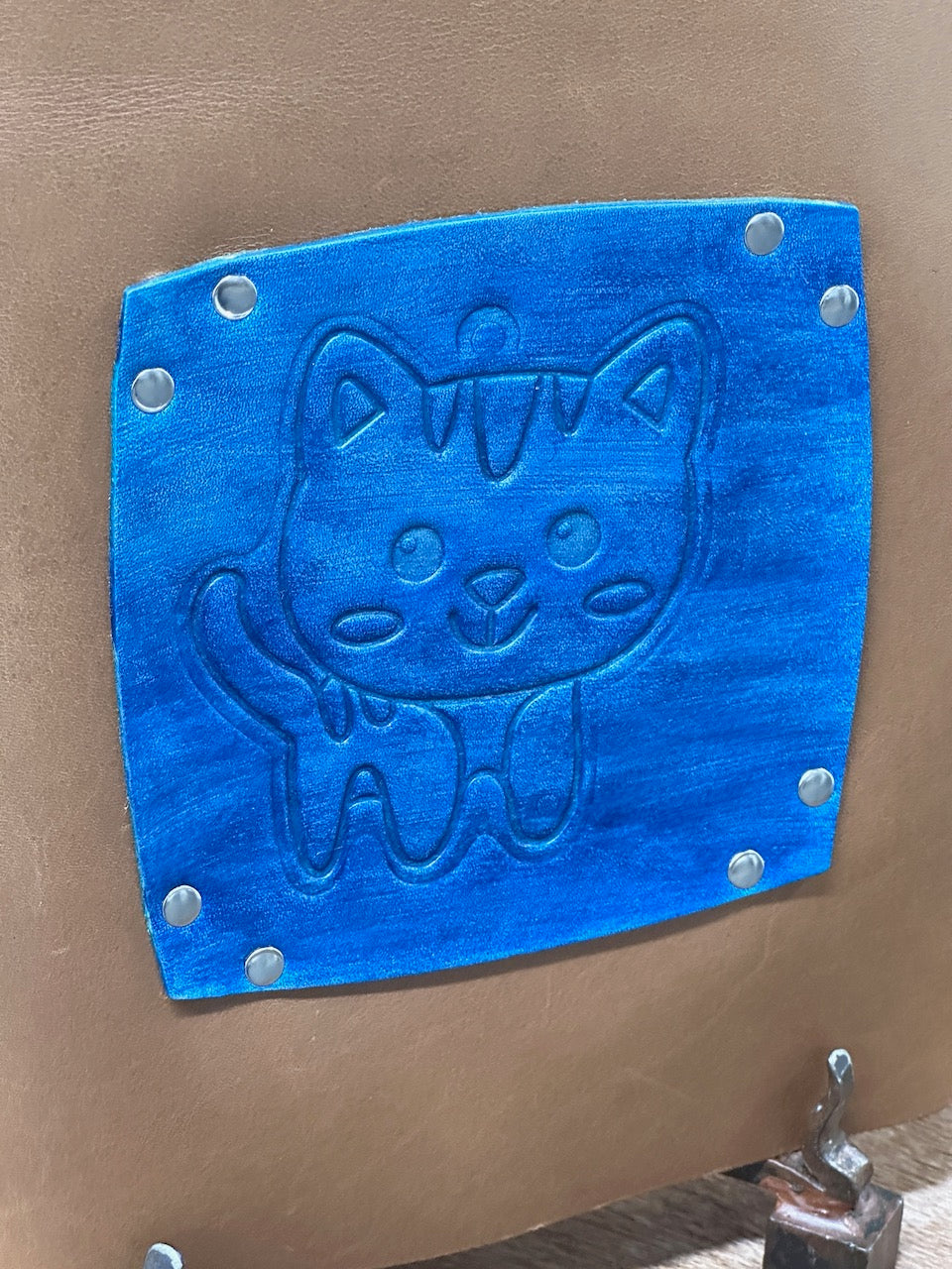 detail embossed cat on blue and brown leather journal