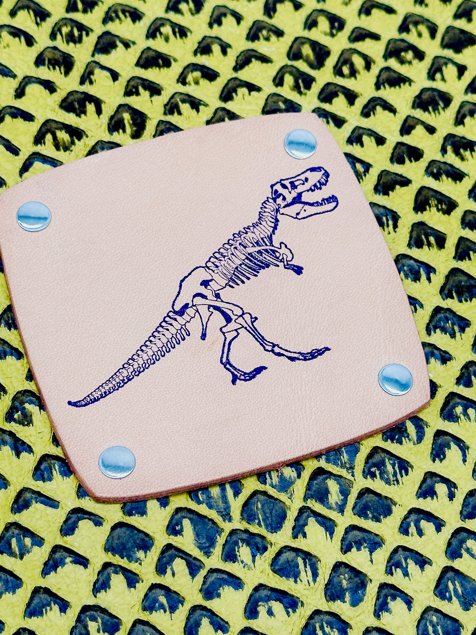 detail stamped tyrannosaurus rex dinosaur on leather journal by undercover popular leather goods