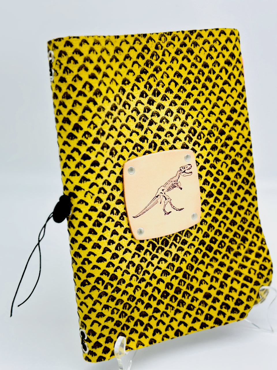 leather journal featuring a dinosaur on the front cover