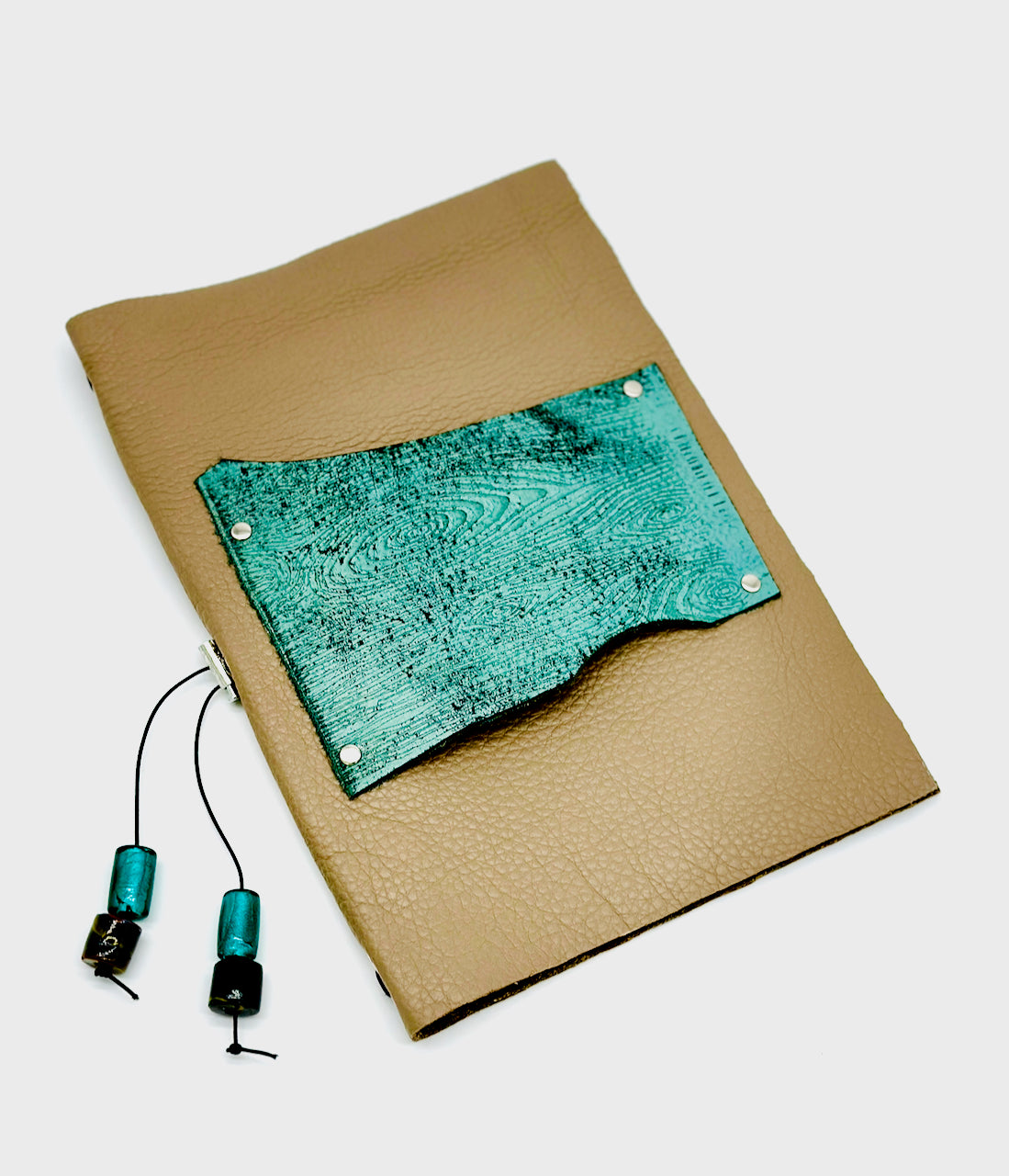 front cover of tan and blue leather journal cover with wood grain embossed detail