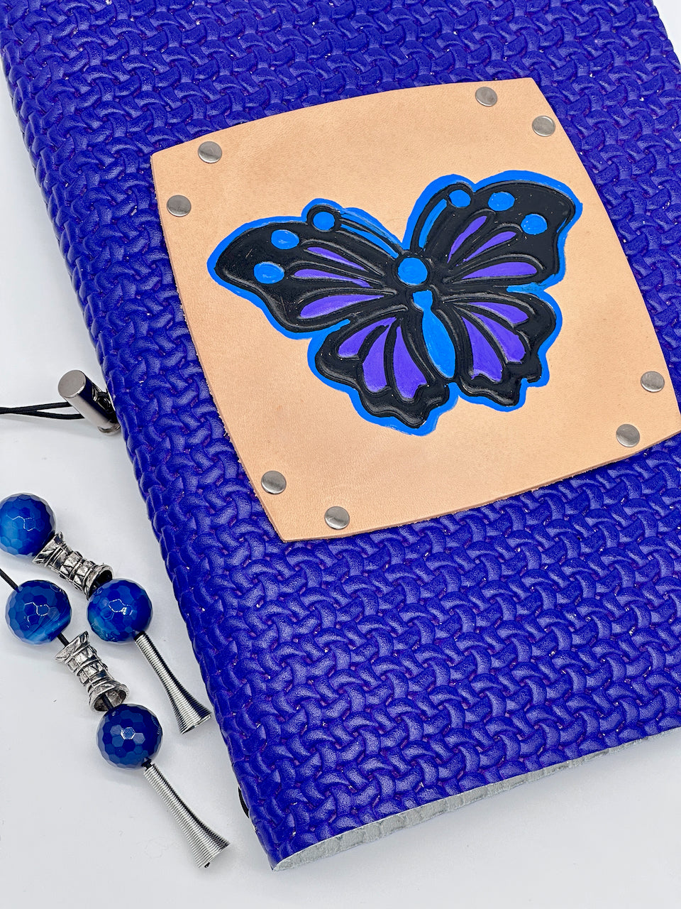 front-cover-leather-bound-lined-paper-refillable-journal-diary-notebook-with a hand inked colored butterfly.