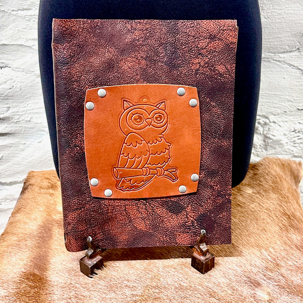 Upright leather journal featuring an embossed owl on brown distressed leather