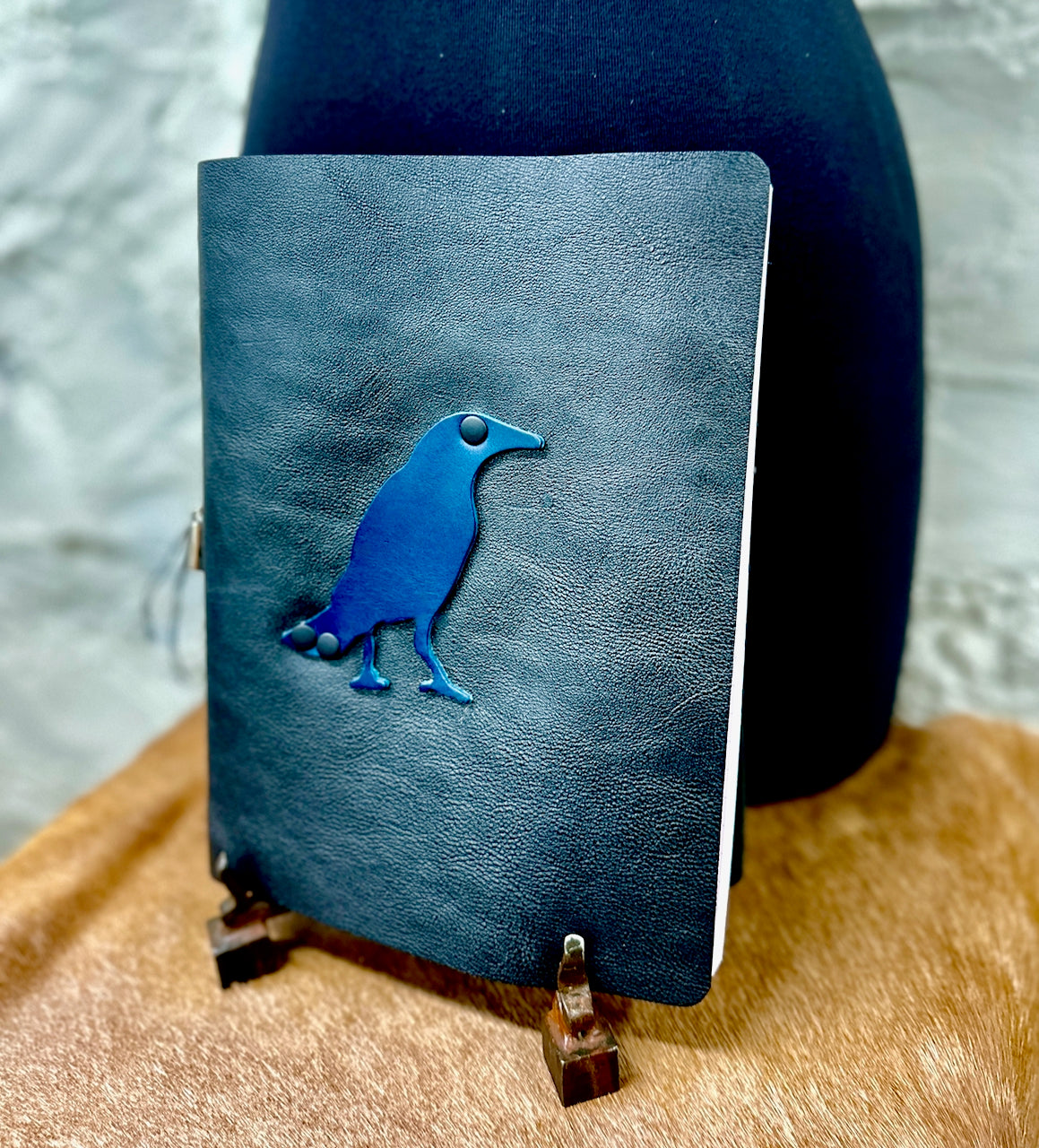 black leather refillable journal with navy leather bird on front cover