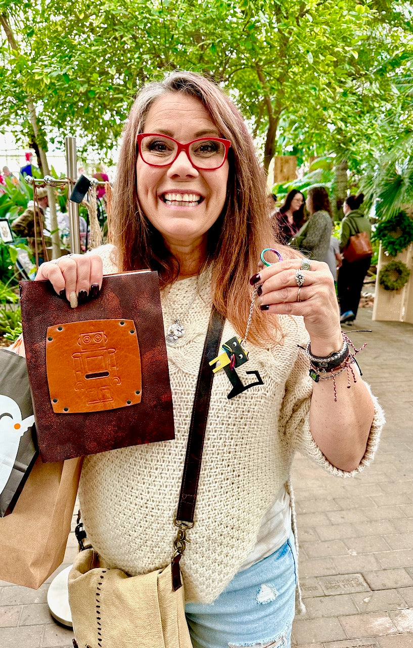 Janiece the happy customer holds her Robbie robot leather refillable journal from Undercover Popular Leather Goods