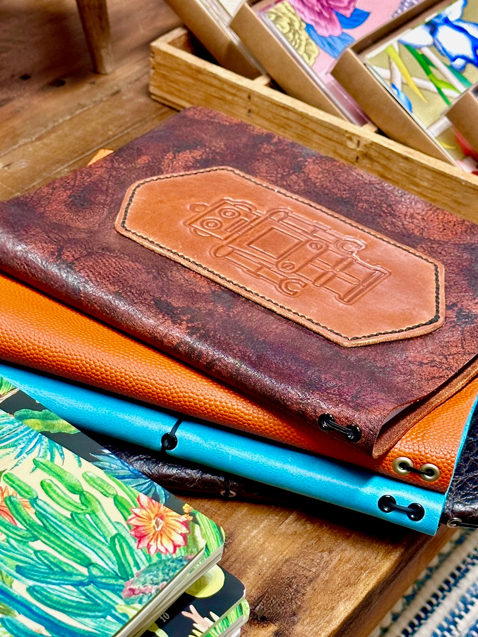 splayed stack of refillable leather journals hand crafted by Undercover Popular Leather Goods in Elkhart, Indiana.