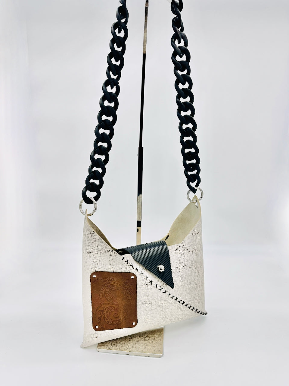 Small bag with black chain strap on a white background