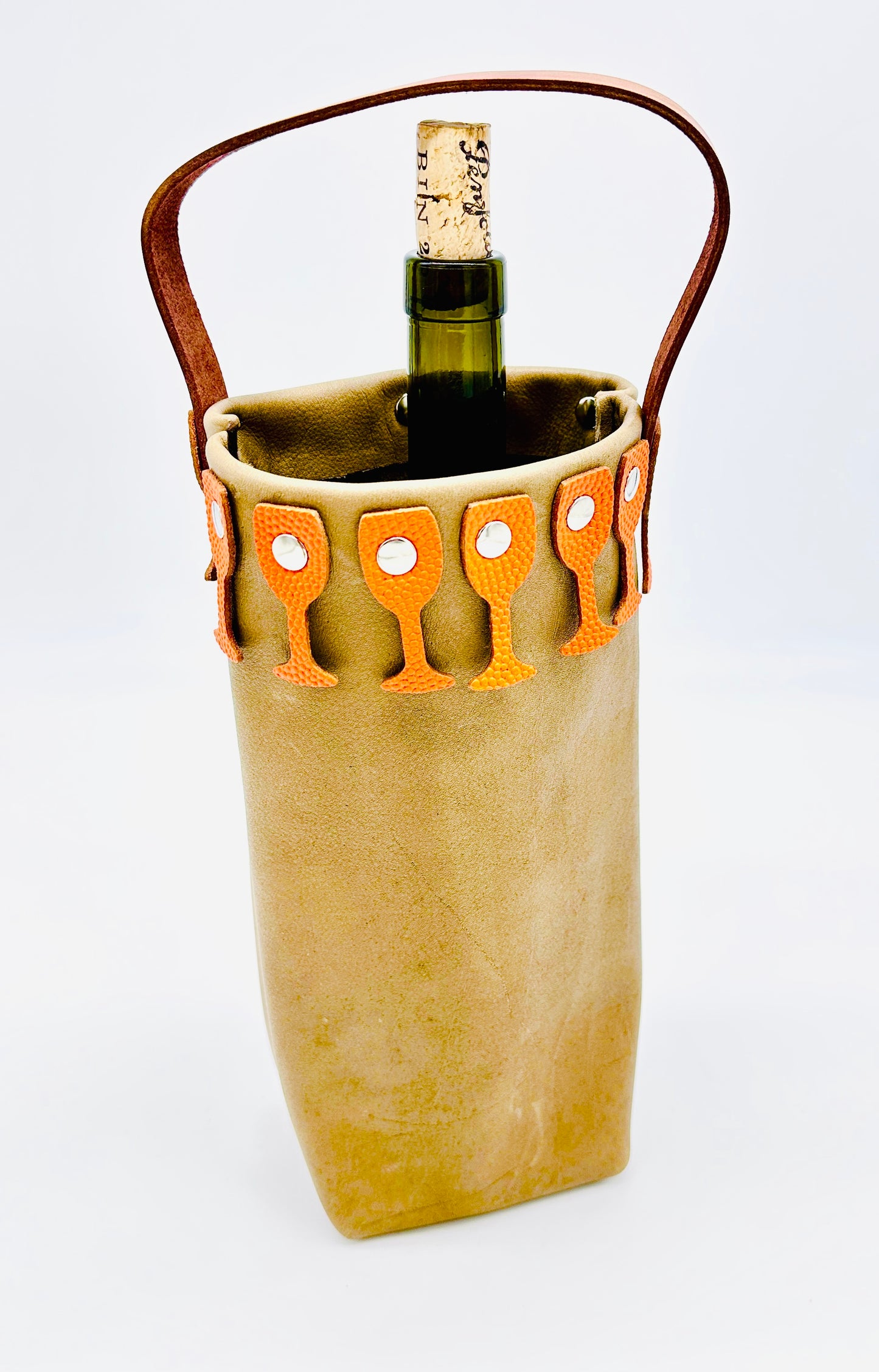 Leather Wine bottle carrier with brown leather handle with orange pebbled leather glass border on a white background