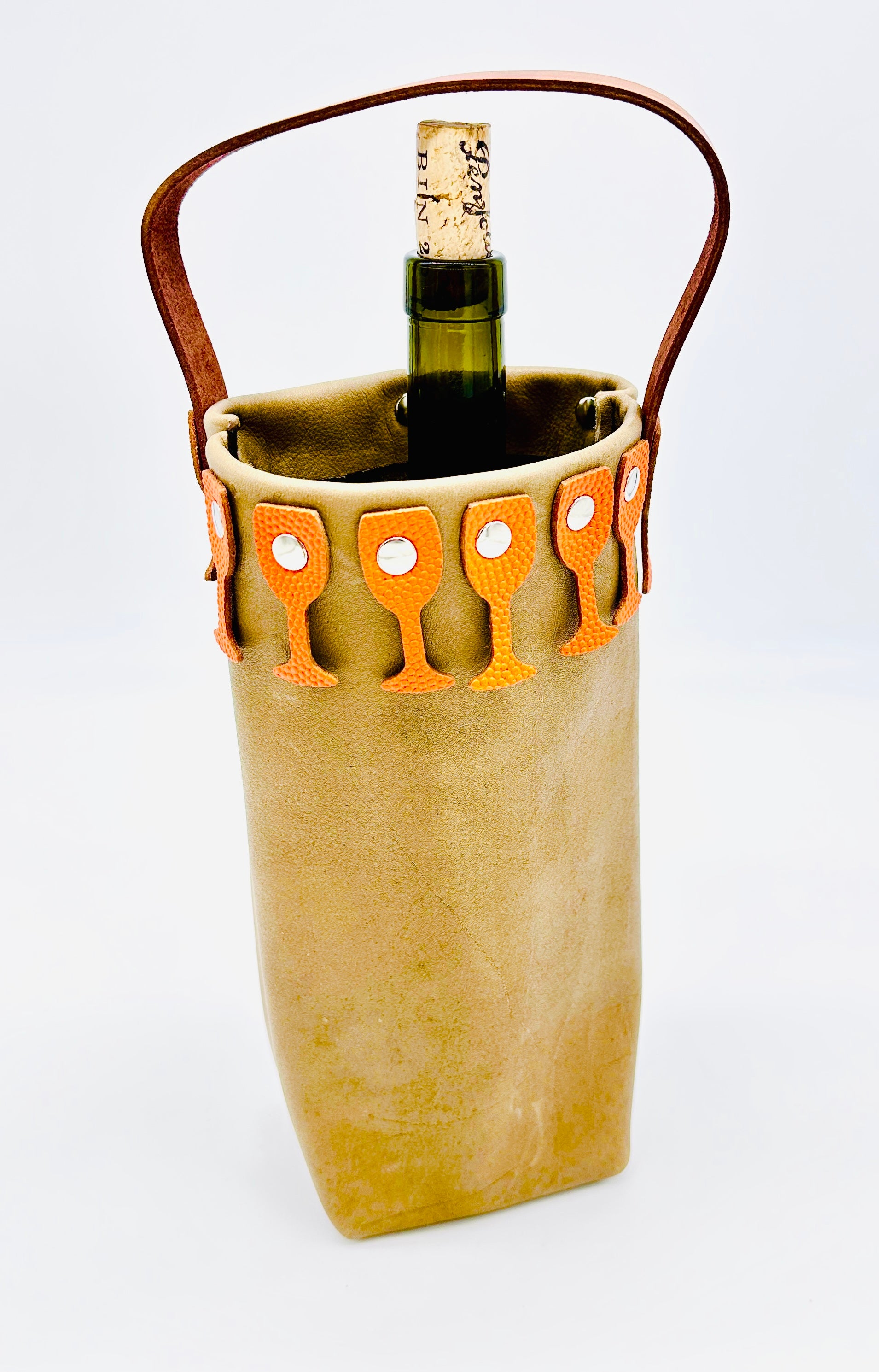 Leather Wine bottle carrier with brown leather handle with orange pebbled leather glass border on a white background