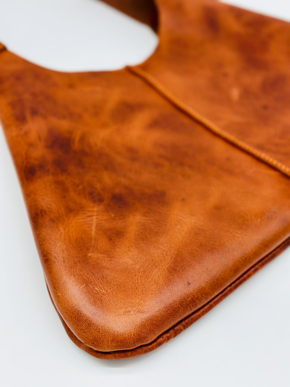 Close-up of a orange/ brown leather product on a white background