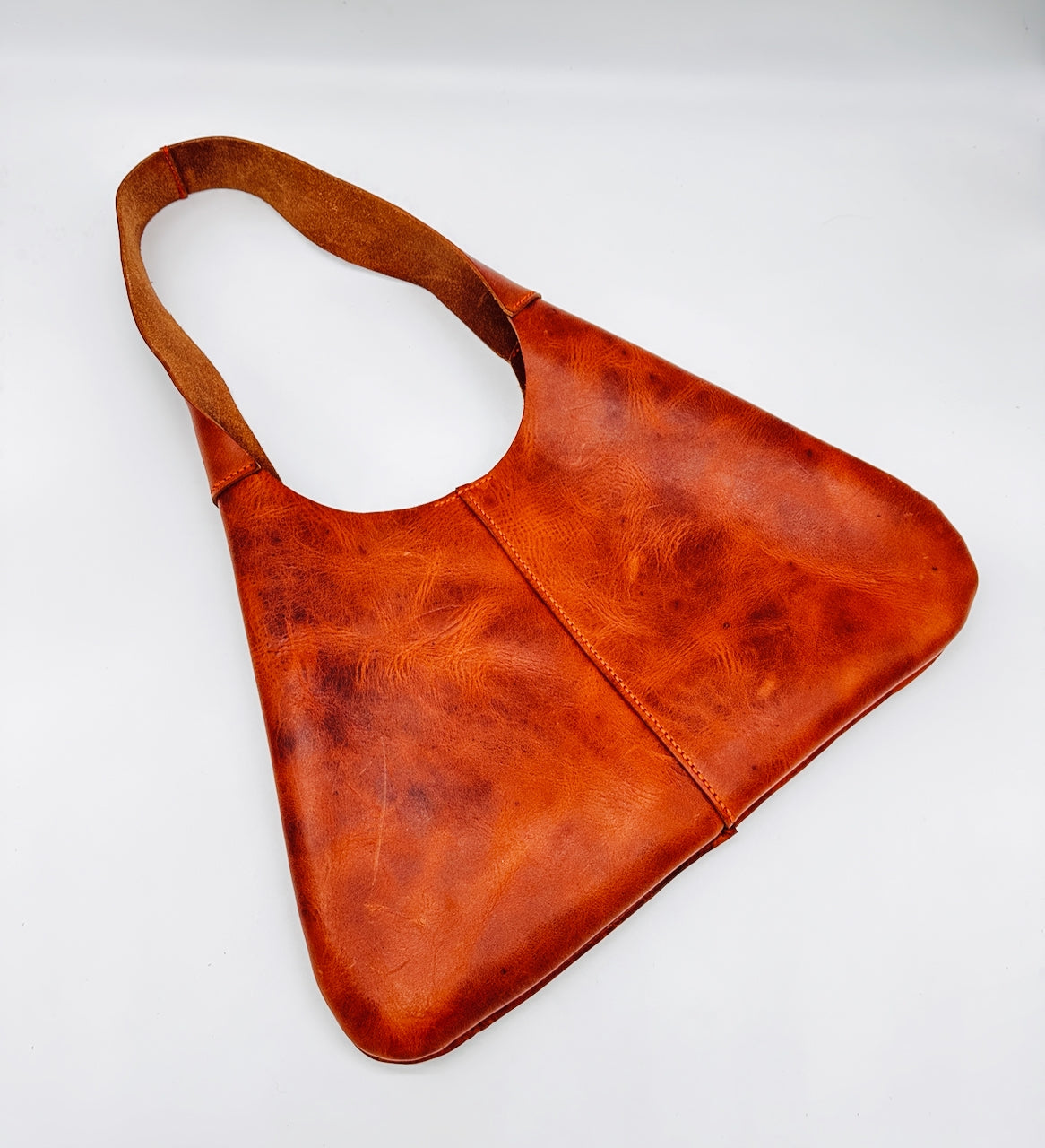 Orange leather handbag on a white background