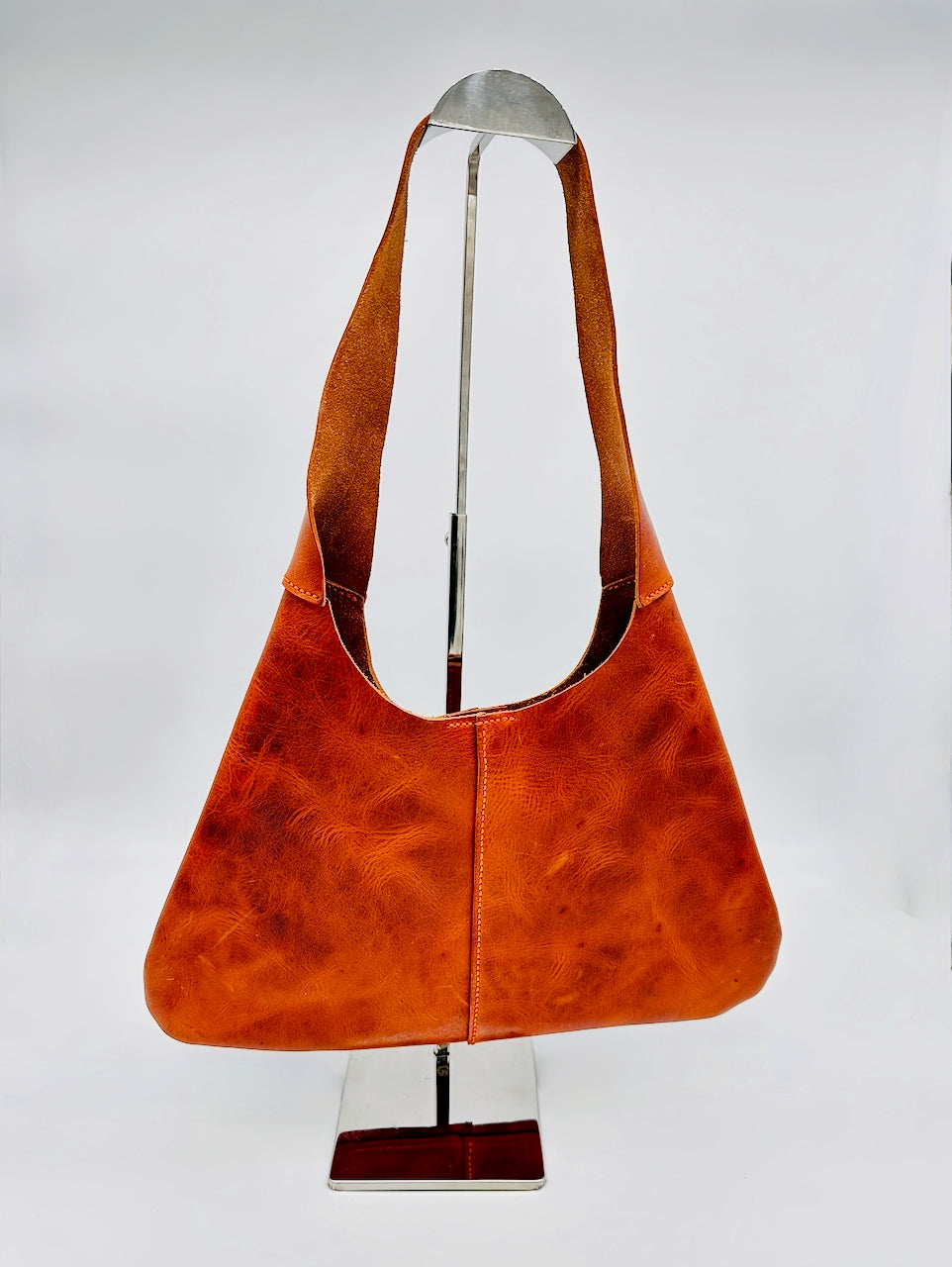 Orange leather handbag on a white background