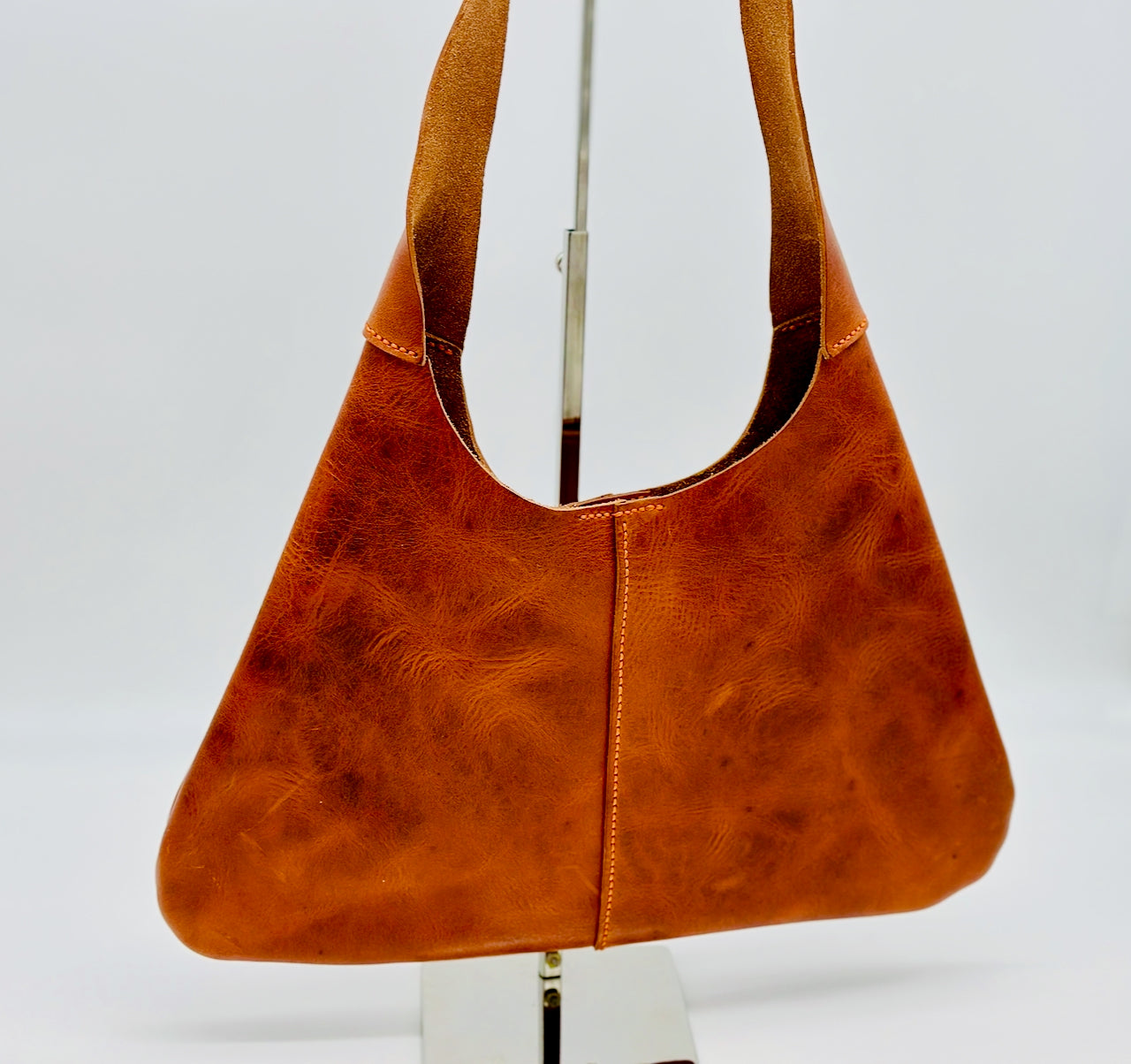 Orange leather handbag on a white background