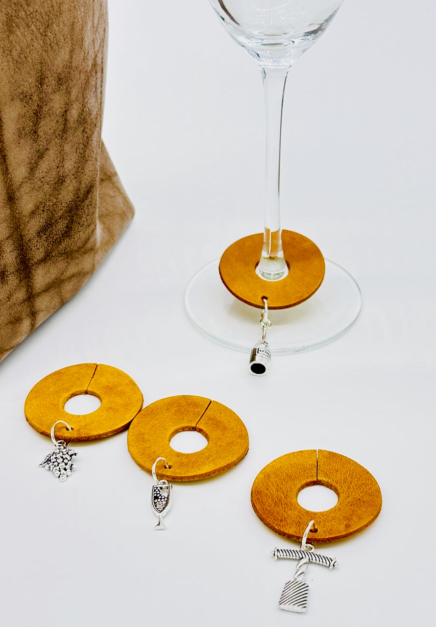 Yellow circular glass charms next to a champagne glass.