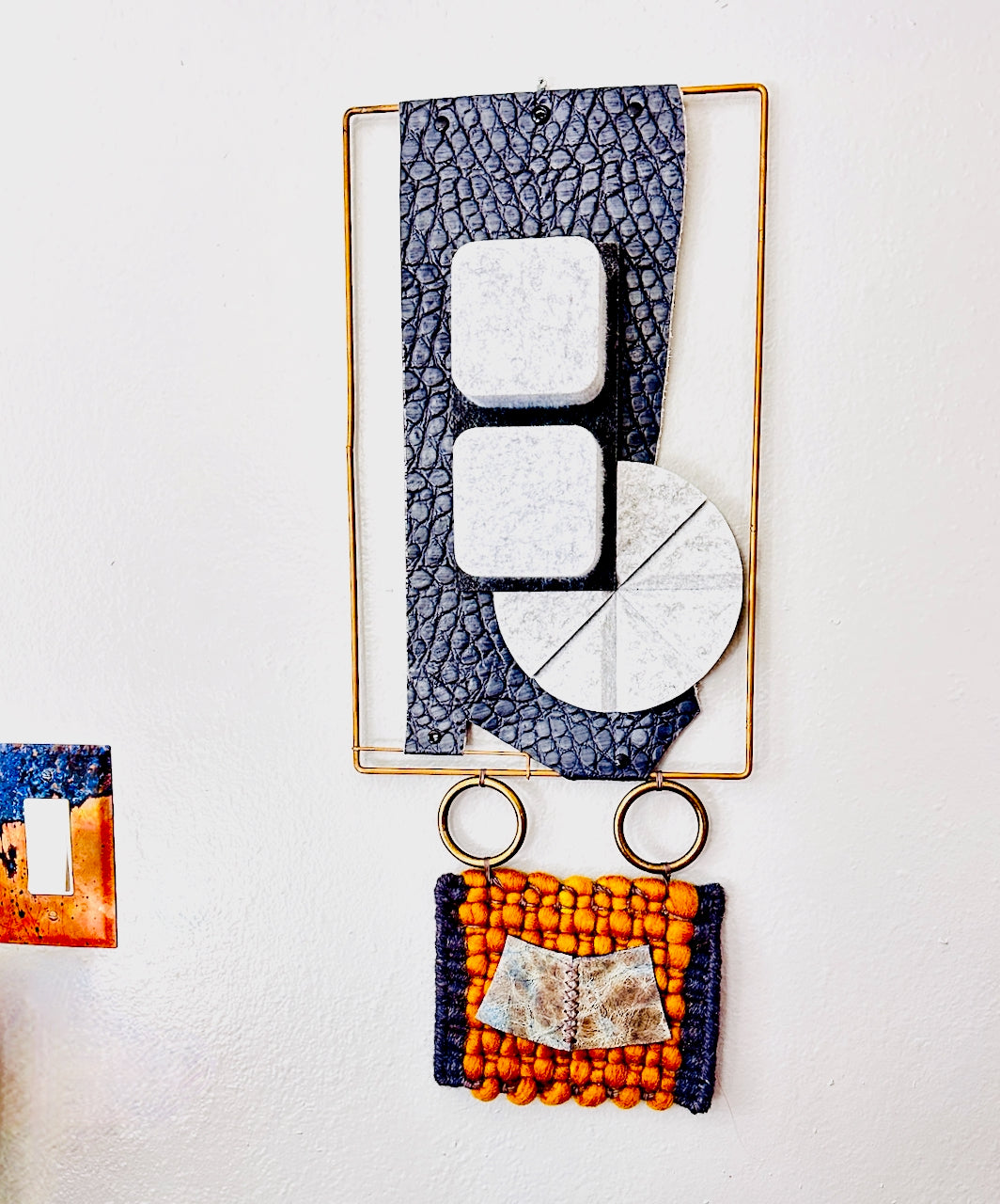 Decorative wall art with geometric shapes and textured patterns on a white background