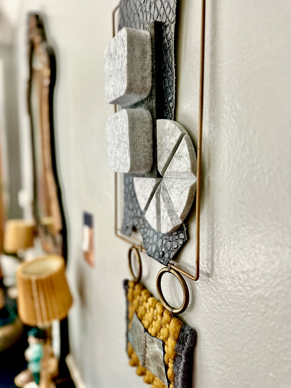 Decorative wall art with geometric shapes on a white wall