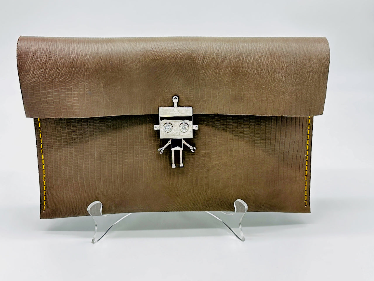 Gray leather clutch bag with a robot clasp on a white background