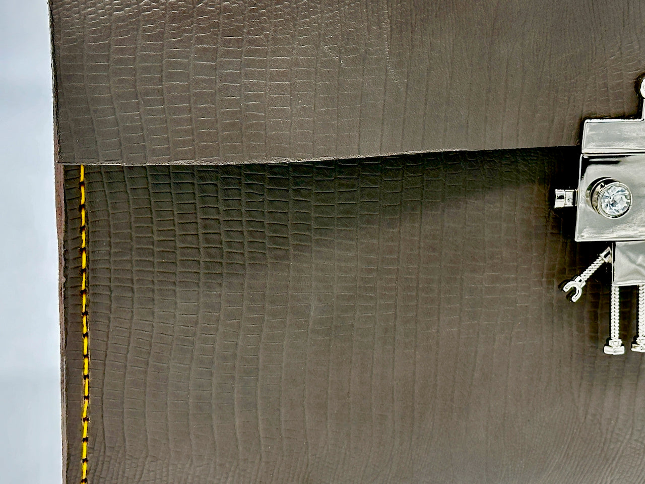 Close-up of a textured gray surface with a metallic object on the right side.