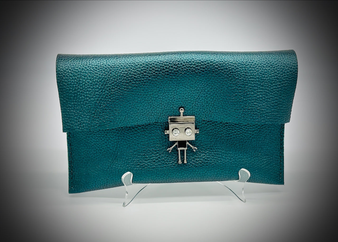 Green metallic leather clutch bag with a robot clasp on a gray background