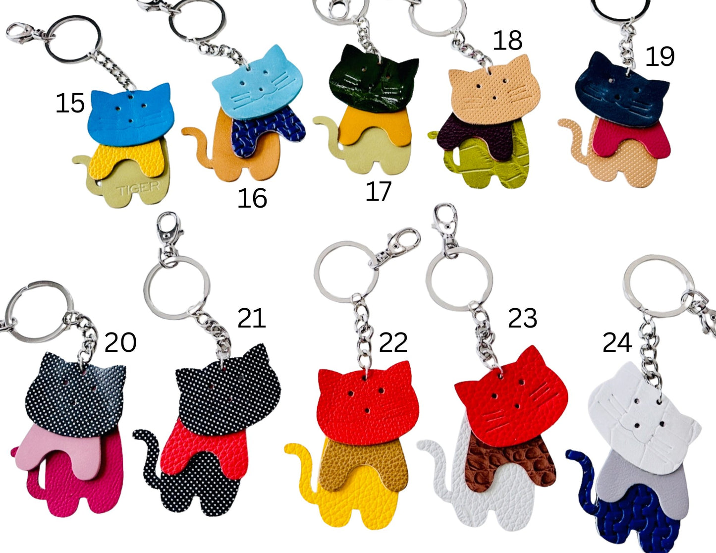 Collection of colorful cat-shaped keychains on a white background