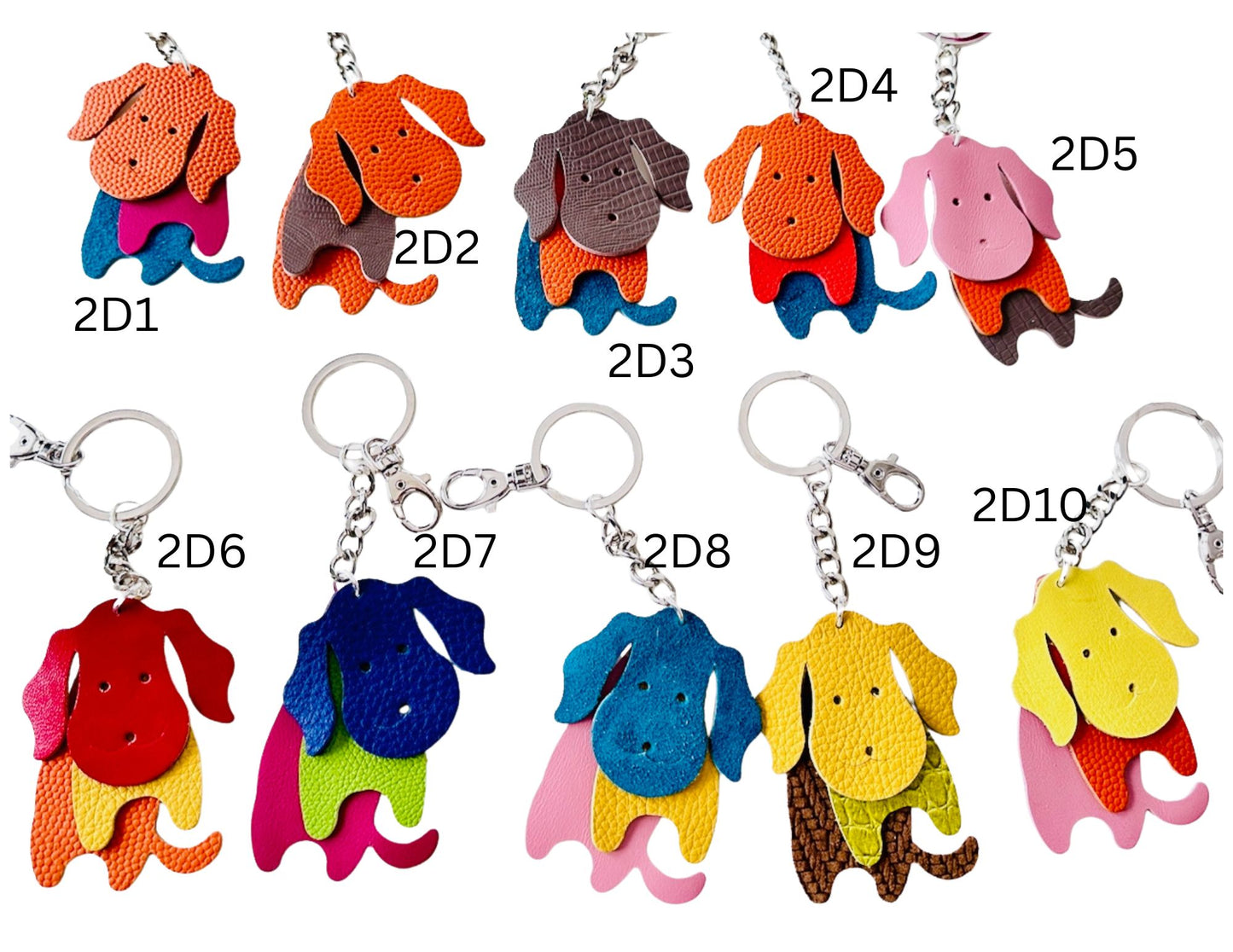 Colorful dog-shaped leather keychains on a white background
