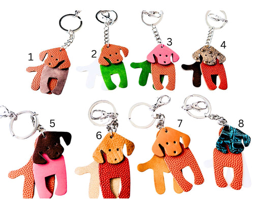 Set of colorful leather dog-shaped keychains made by Undercover Popular Leather Goods on a white background