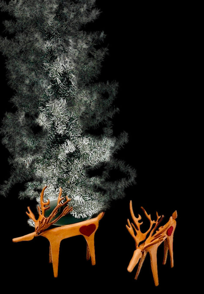 Decorative Christmas tree with two leather
 deer figures on a black background