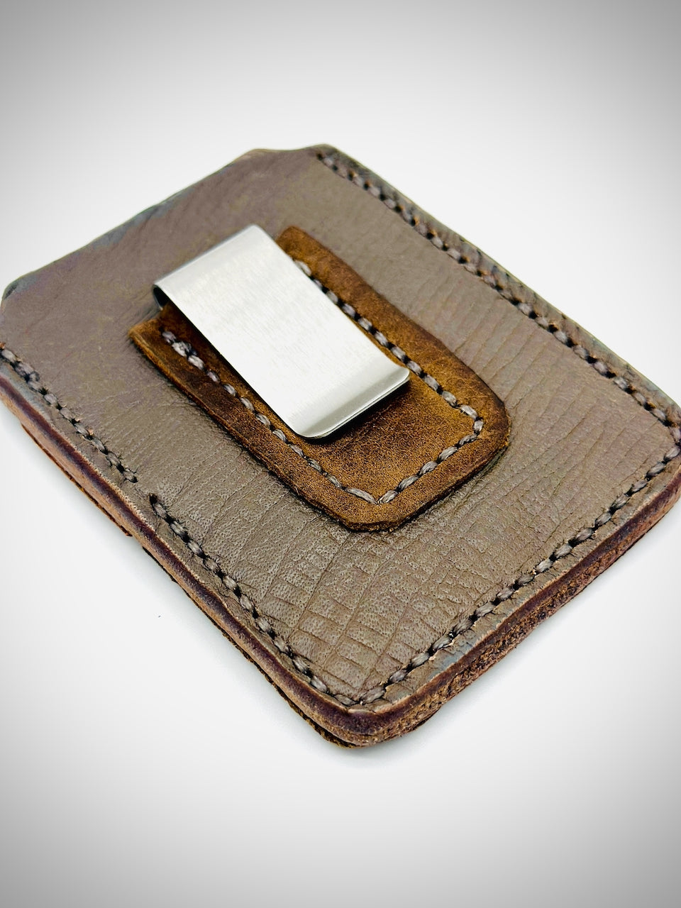 Gray and Brown leather money clip on a light background