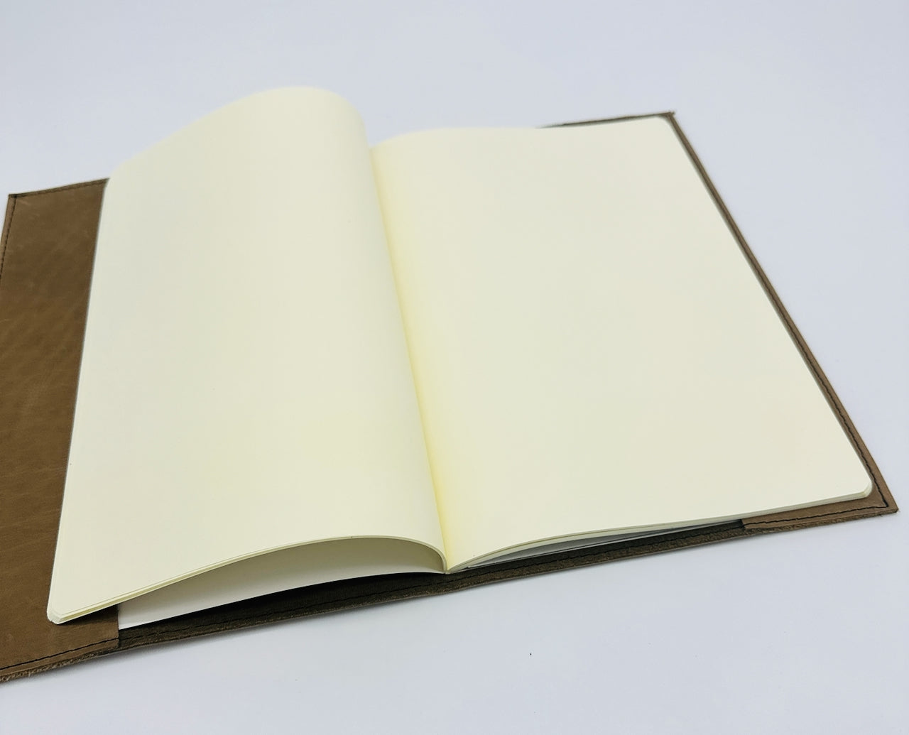 Open notebook with blank pages on a white background