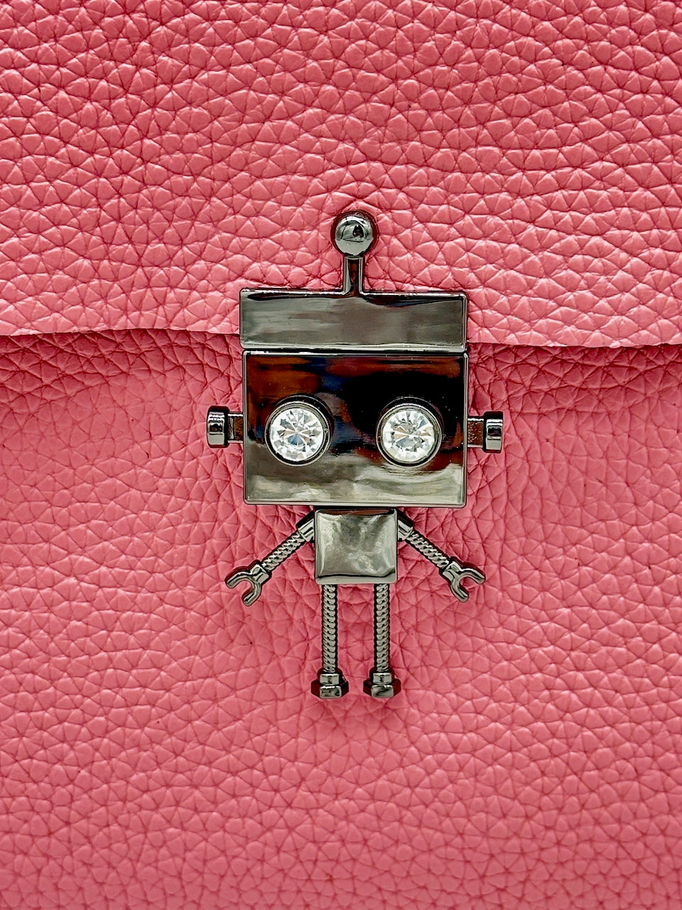 Metallic robot clasp on a pink textured leather purse