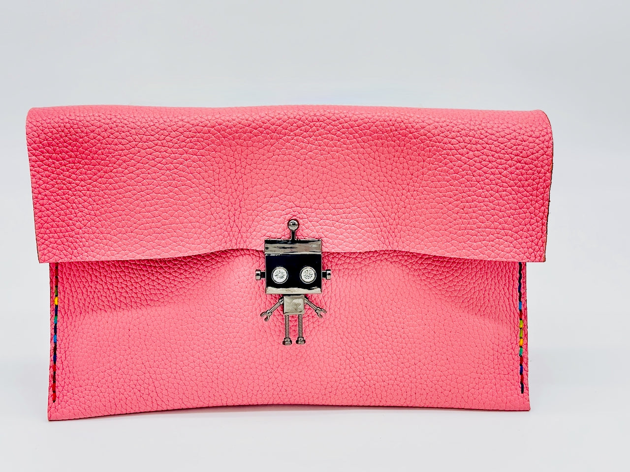 Pink clutch bag with a robot clasp on a light background
