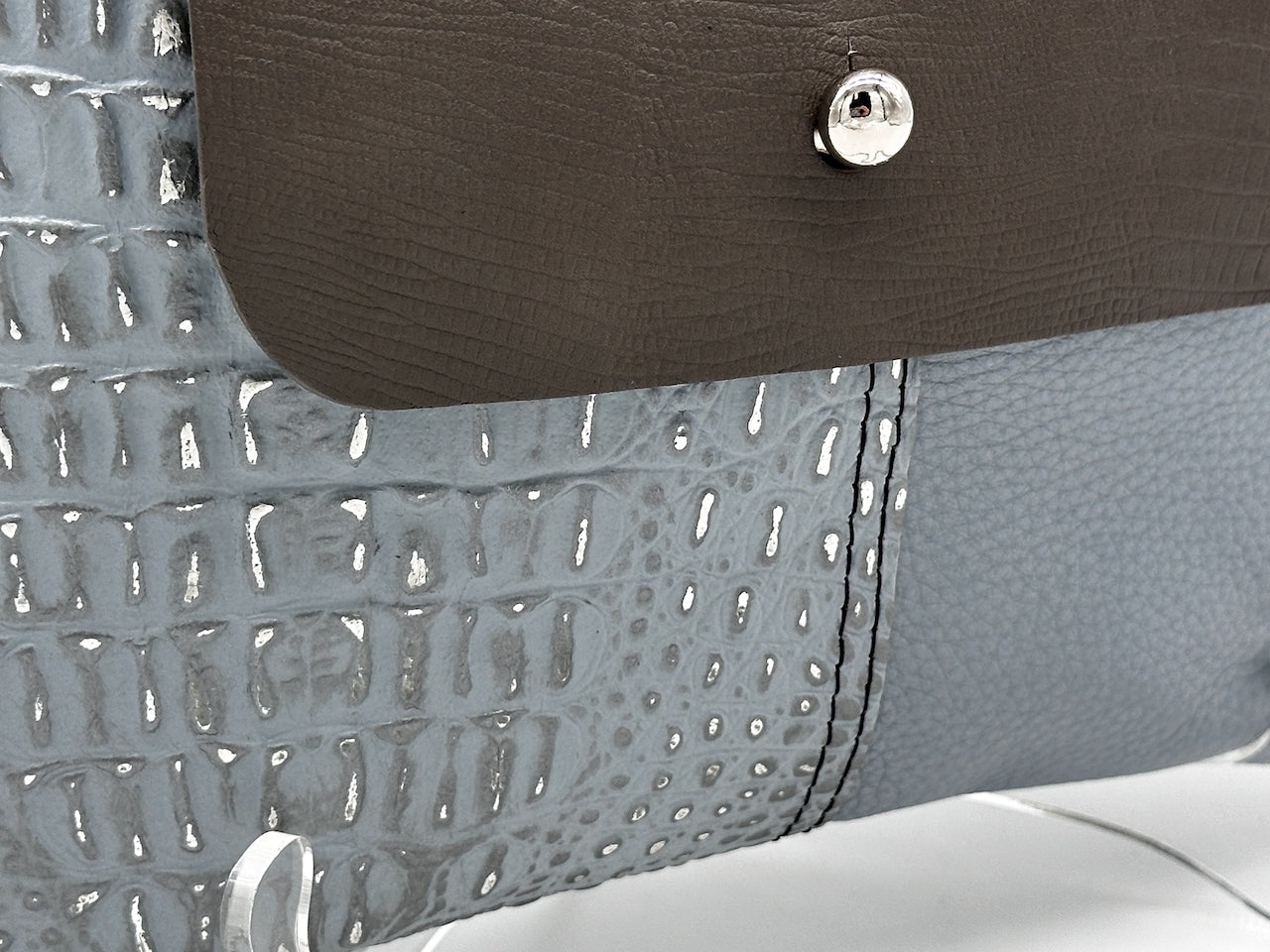 bottom of front of blue and gray leather purse