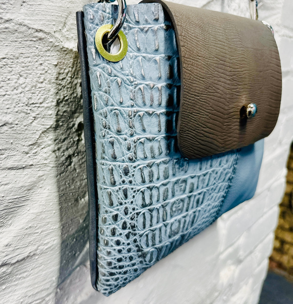 side angle leather purse hanging on wall