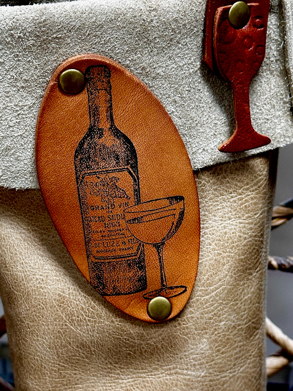 leather stamp illustrated with image of wine bottle and glass