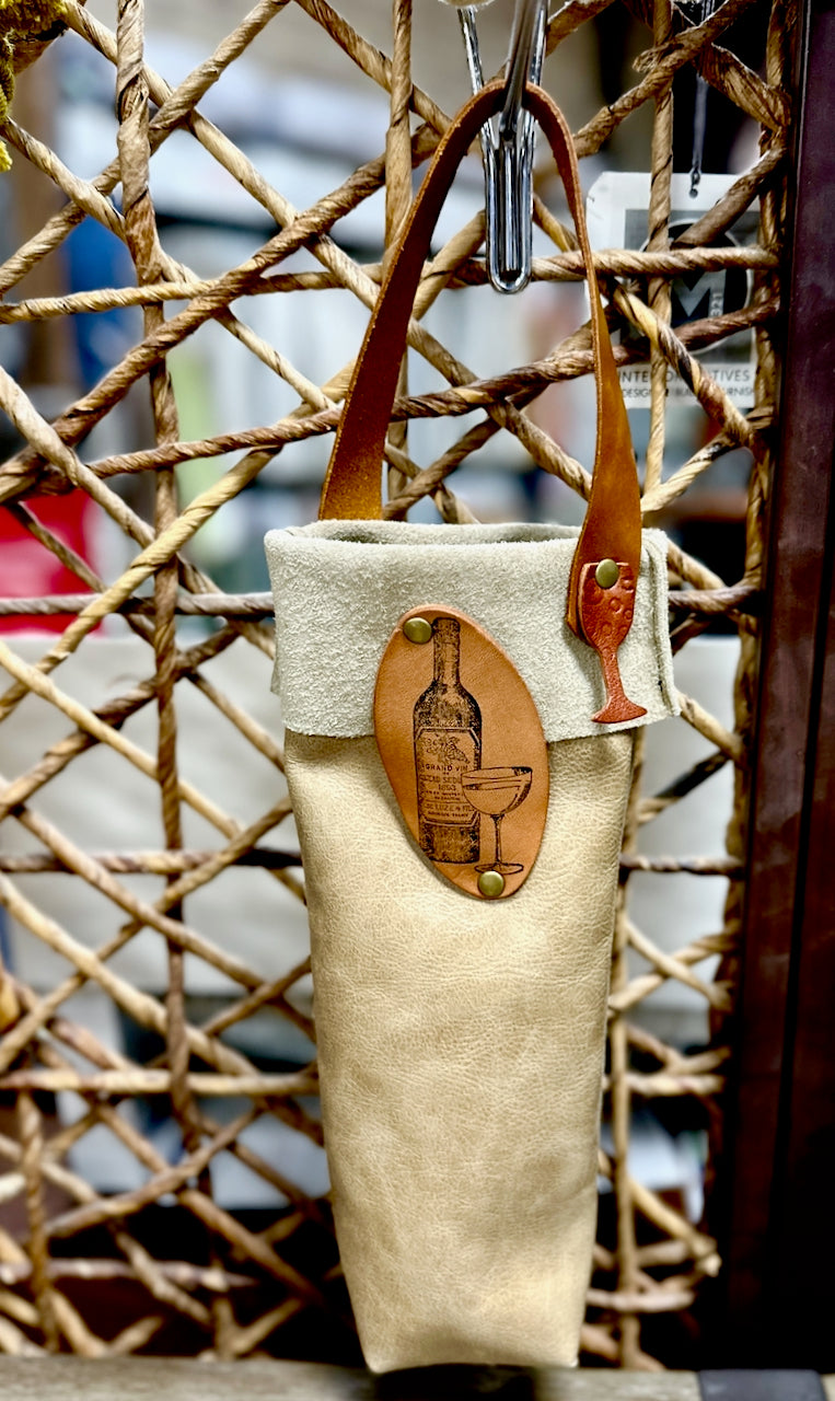 Beautiful handmade leather wine bottle carriers with image of wine bottle and glass hangs on screen