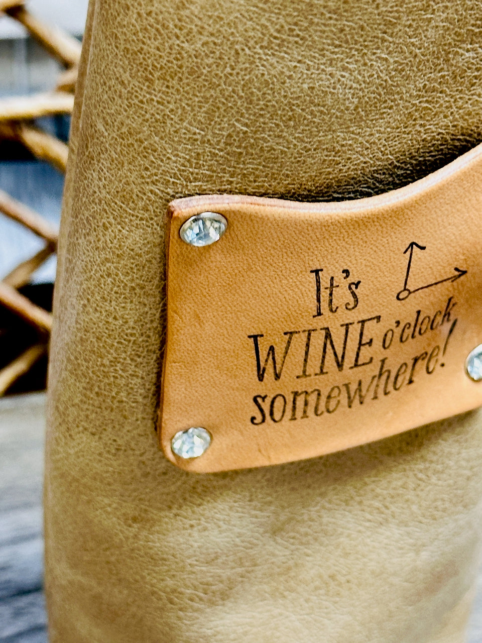 closeup of stamped leather patch on wine bottle carrier