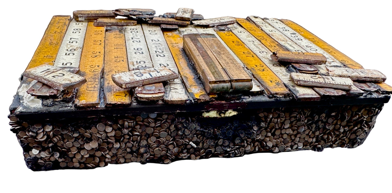 Wooden box with vintage rulers and tools 